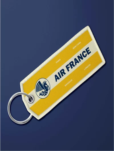 Porte-clé en tissu "flamme" Air France vintage jaune. Très maniable, il se glisse partout et permet vite de retrouver ses clés.